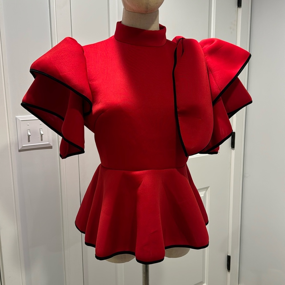 Beautiful dramatic top with puff sleeve and bow. True red with black outline .
